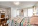 Spacious bedroom with hardwood floors, ceiling fan, walk-in closet and views of ensuite bathroom at 2700 Nebraska Ave # 3-201, Palm Harbor, FL 34684
