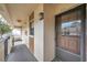 Exterior view of unit 201 featuring a secure front entry door, and private covered porch at 2700 Nebraska Ave # 3-201, Palm Harbor, FL 34684