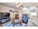 Open-concept living room with hardwood floors, ceiling fan and sliding glass doors with natural light at 2700 Nebraska Ave # 3-201, Palm Harbor, FL 34684
