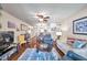 Cozy living room with ceiling fan, comfortable seating, hardwood floors, and views into the open dining area at 2700 Nebraska Ave # 3-201, Palm Harbor, FL 34684