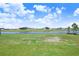 Well-manicured lawn leads to the lake at 5211 Lake Venice Dr, Wimauma, FL 33598