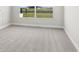 Bedroom with plush gray carpeting, white walls, and a window overlooking a water view at 5211 Lake Venice Dr, Wimauma, FL 33598