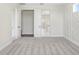 This modern bedroom boasts new carpets, white doors, and decorative wall accents at 5211 Lake Venice Dr, Wimauma, FL 33598