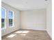 Sunlit bedroom with wood floors, decorative wall trim, and large windows at 5211 Lake Venice Dr, Wimauma, FL 33598