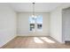 Bright dining room featuring a modern chandelier and large windows with natural light at 5211 Lake Venice Dr, Wimauma, FL 33598