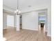 Elegant dining area with wood floors, modern lighting, and an open layout at 5211 Lake Venice Dr, Wimauma, FL 33598