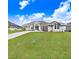 Inviting one-story home with a green lawn and beautifully designed facade at 5211 Lake Venice Dr, Wimauma, FL 33598