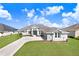 Attractive single-story home with a long driveway and lush green lawn at 5211 Lake Venice Dr, Wimauma, FL 33598