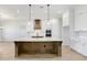 Kitchen features a large island with white countertops, white cabinets, and stainless steel appliances at 5211 Lake Venice Dr, Wimauma, FL 33598