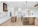 Modern kitchen featuring a center island with a farmhouse sink, white cabinets, and wooden accents at 5211 Lake Venice Dr, Wimauma, FL 33598