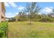 Expansive backyard featuring lush greenery and ample space for outdoor activities and relaxation at 6307 Brevada Ln, Apollo Beach, FL 33572