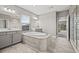 Luxurious bathroom with a soaking tub, double sinks, and tile flooring at 6307 Brevada Ln, Apollo Beach, FL 33572