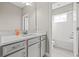 Bright bathroom featuring gray vanity, white countertops, and a shower-tub combination at 6307 Brevada Ln, Apollo Beach, FL 33572