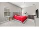Well lit bedroom with a large bed, treadmill, and cozy seating area at 6307 Brevada Ln, Apollo Beach, FL 33572