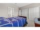 Bedroom features a large closet, a view of the bathroom, and a bed with a blue comforter at 6307 Brevada Ln, Apollo Beach, FL 33572