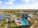 Aerial view of a community pool and fitness center overlooking a lake with palm trees at 6307 Brevada Ln, Apollo Beach, FL 33572