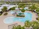 Aerial view of a community pool featuring a slide, seating, a area, and palm trees at 6307 Brevada Ln, Apollo Beach, FL 33572