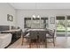 Charming dining area with modern lighting and beautiful windows and access to the backyard patio at 6307 Brevada Ln, Apollo Beach, FL 33572