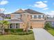 Charming two-story home with landscaped front yard and a two car garage in the daytime at 6307 Brevada Ln, Apollo Beach, FL 33572