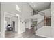 Open-concept foyer featuring hardwood floors, high ceilings and a staircase with iron railing at 6307 Brevada Ln, Apollo Beach, FL 33572