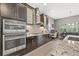 Modern kitchen featuring built in appliances, ample counter space, stylish backsplash and a view to the backyard at 6307 Brevada Ln, Apollo Beach, FL 33572