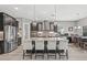 Spacious kitchen boasts stainless steel appliances, a large island with bar seating, and elegant pendant lighting at 6307 Brevada Ln, Apollo Beach, FL 33572