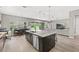 Gourmet kitchen featuring a large island, stainless steel appliances and an open floor plan at 6307 Brevada Ln, Apollo Beach, FL 33572