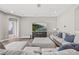 Spacious living room featuring hardwood floors and a large sectional sofa with stylish decor at 6307 Brevada Ln, Apollo Beach, FL 33572