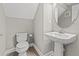 Cozy powder room with pedestal sink, modern fixtures, and neutral color scheme at 6307 Brevada Ln, Apollo Beach, FL 33572