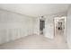 Bright, open bedroom with tiled floors, neutral walls, and doorway leading to updated bathroom at 7300 Sunshine Skyway S Ln # 108, St Petersburg, FL 33711