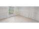 Bedroom with tiled floors, a large window with blinds, and neutral colored walls at 7300 Sunshine Skyway S Ln # 108, St Petersburg, FL 33711