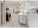 Open concept: modern kitchen and living room area with tile floors and an ocean view at 7300 Sunshine Skyway S Ln # 108, St Petersburg, FL 33711