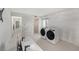 Laundry room featuring a sink, washer and dryer, and tile flooring at 7300 Sunshine Skyway S Ln # 108, St Petersburg, FL 33711