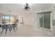 Living room featuring tile floors, dining table, sliding glass doors, and elegant light fixture at 7300 Sunshine Skyway S Ln # 108, St Petersburg, FL 33711