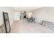 Open-concept living room with tiled flooring, dining area, and modern lighting at 7300 Sunshine Skyway S Ln # 108, St Petersburg, FL 33711