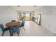 Living room with tiled floors, dining table, and sliding doors to the patio at 7300 Sunshine Skyway S Ln # 108, St Petersburg, FL 33711