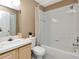Neutral bathroom featuring a shower-tub combo with white tile and simple vanity at 8811 Casablanca Way, Tampa, FL 33626