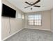 This bedroom features neutral walls, gray carpet, a ceiling fan and a window with blinds at 8811 Casablanca Way, Tampa, FL 33626