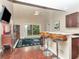 Open-concept dining room features hardwood floors, a breakfast bar, and patio door with backyard view at 8811 Casablanca Way, Tampa, FL 33626