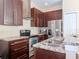 Modern kitchen featuring stainless steel appliances, dark wood cabinets, and granite countertops at 8811 Casablanca Way, Tampa, FL 33626