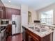 Bright kitchen with stainless steel appliances, granite countertops, and dark wood flooring at 8811 Casablanca Way, Tampa, FL 33626