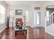 Open living room with gleaming hardwood floors and natural light streaming through windows at 8811 Casablanca Way, Tampa, FL 33626
