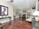 Open living area with gleaming hardwood floors and natural light through large windows at 8811 Casablanca Way, Tampa, FL 33626