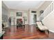 Spacious living room featuring hardwood floors, large windows, and staircase at 8811 Casablanca Way, Tampa, FL 33626