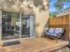 Outdoor patio with a cozy wicker chair and sliding glass doors to the interior at 8811 Casablanca Way, Tampa, FL 33626