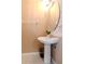 Cozy half bathroom, features a pedestal sink with vanity, and neutral walls at 8811 Casablanca Way, Tampa, FL 33626