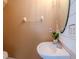 Cozy half bathroom, features a pedestal sink with vanity, and neutral walls at 8811 Casablanca Way, Tampa, FL 33626