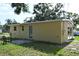 Rear house view with small patio and neatly kept lawn at 11798 104Th St, Largo, FL 33773