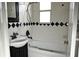Bathroom with black and white tiles, and a shower and tub at 11798 104Th St, Largo, FL 33773