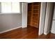 Bedroom with hardwood floors, a closet, and a window with white blinds at 11798 104Th St, Largo, FL 33773